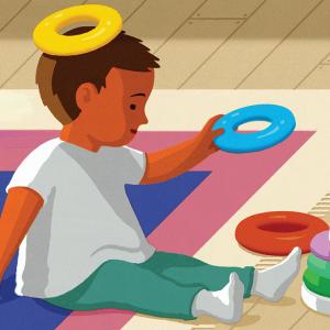 An illustration of a child with red-brown skin and dressed in white socks and a white shirt with teal pants  sitting on a rug while playing with a ring stacker toy; a yellow ring sits on its head like a halo.