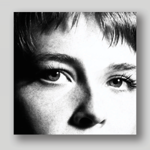 The cover art of Maggie Roger's music album 'Surrender', which features a black-and-white closeup of the singer's eyes.