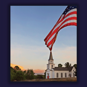 The image shows a white church with a steeple over a sunset and there is an American flag waving. 