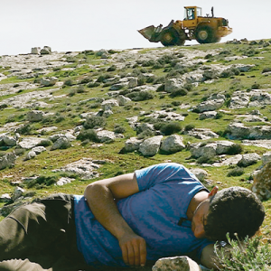 Palestinian film director Basel Adra lays with his camera in his homeland, the Israeli-occupied region of Masafer Yatta. 