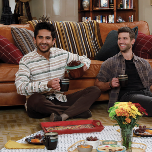 Awalmir and Riley eat a meal on the floor of the living room