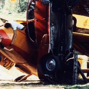 A still from the film Weekend where the characters are climbing and exploring a grounded plane.