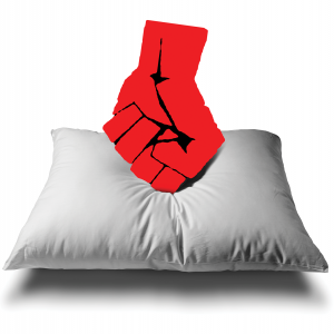A balled fist is punching downward onto a pillow.