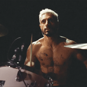 A drummer sits at his drum set in a scene from 'Sound of Metal'