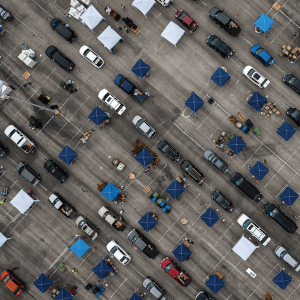Aerial view of cars waiting in a food line in a parking lot in Texas.