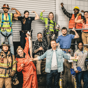 Contestants from the reality show "Tough As Nails" are blue collar workers. A group of 13 poses for a photo.