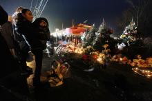 Isabel Lebron holds son Izaiah Taylor at a memorial with donated Christmas trees honoring victims. Mario Tama/Getty Images Mario Tama/Getty Images