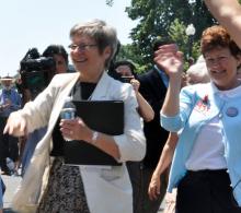 Sister Simone Campbell and Sister Mary Ellen Lacy step off the bus on Monday. Photo by Sandi Villarreal / Sojourners Photo by Sandi Villarreal / Sojourners