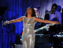 Whitney Houston sings at a 2011 pre-Grammy Awards event. Photo via Getty Images.