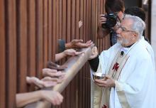 Bishop Gerald Kicanas of distributes communion in Arizona. Creative Commons image by Roman Catholic Archdiocese of Boston/RNS