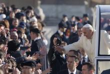 Pope Francis greets the pilgrims in St. Peter's square. giulio napolitano/Shutterstock giulio napolitano/Shutterstock