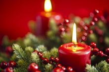 An advent candle burns in the wreath. Image courtesy 3523studio/shutterstock.com. An advent candle burns in the wreath. Image courtesy 3523studio/shutterstock.com