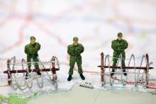 Miniature border patrol guards stand on a map at the USA/Mexico border. Amy Walters / Shutterstock Amy Walters / Shutterstock