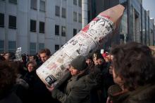 A protester holds a giant pencil at a march in support of free speech for Charlie Hebdo. Photo via CRM / Shutterstock.com Photo via CRM / Shutterstock.com