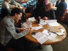 Volunteers Bill Boulden, left, and Jim Oliver, write letters to prisoners. Photo: Sarah Kaiser, Center for Inquiry Via RNS