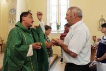 Joseph Haegele receives communion at St. Gertrude parish in Grantfork, Ill. RNS photo by Johnny Andrews/St. Louis Post-Dispatch RNS photo by Johnny Andrews/St. Louis Post-Dispatch
