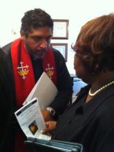 The Rev. William J. Barber II consults with church member Shyrl Hinnant Uzzell. RNS photo by Yonat Shimron