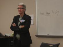 Dr. H. Adam Ackley tells his students of his transgender identity, writing his preferred name on the board. Photo by Annie Z. Yu