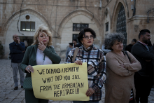 Members of the Armenian community protest a contentious deal that stands to displace residents and hand over a large section of the Armenian Quarter in the Old City of Jerusalem, Friday, May 19, 2023.