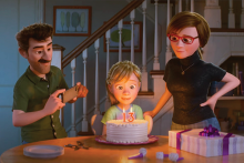 Image of Inside Out 2 where Riley is sitting in front of a birthday cake with her parents by her side.