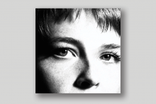 The cover art of Maggie Roger's music album 'Surrender', which features a black-and-white closeup of the singer's eyes.