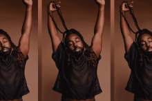 Mykal Kilgore stretches his arms to the sky with his locs wrapped around his hand