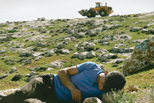 Palestinian film director Basel Adra lays with his camera in his homeland, the Israeli-occupied region of Masafer Yatta. 