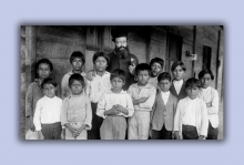 In this vintage photo, a bishop of a church stands among Indigenous children, a scene from 'Exterminate All the Brutes.'