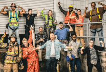 Contestants from the reality show "Tough As Nails" are blue collar workers. A group of 13 poses for a photo.