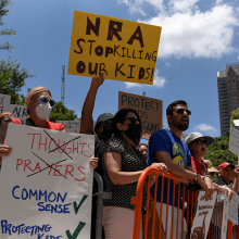 People protest the National Rifle Association annual convention in Houston, Texas on May 27, 2022.
