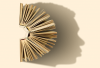 A semi-circle of open books casts the shadow of the profile of a human face