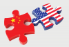 An illustration of two puzzle pieces, one bearing the flag of China while the other bears the flag of the United States. 
